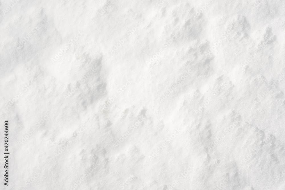 Obraz premium Fresh clean white snow background texture. Winter background with frozen snowflakes and snow mounds. Snow lumps. Seasonal landscape details. Cold weather.