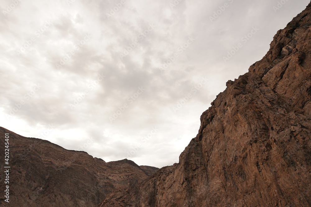 Cliffs in the Gamkab valley of southern Namibia against a cloudy sky Cliffs in the Gamkab valley of southern Namibia against a cloudy sky