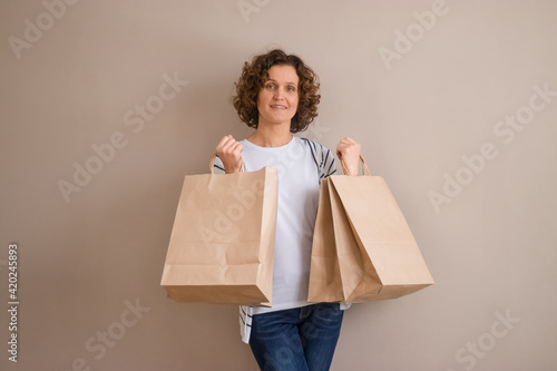 Empty space for text. Shopping. A woman 45 years old with shopping bags.
