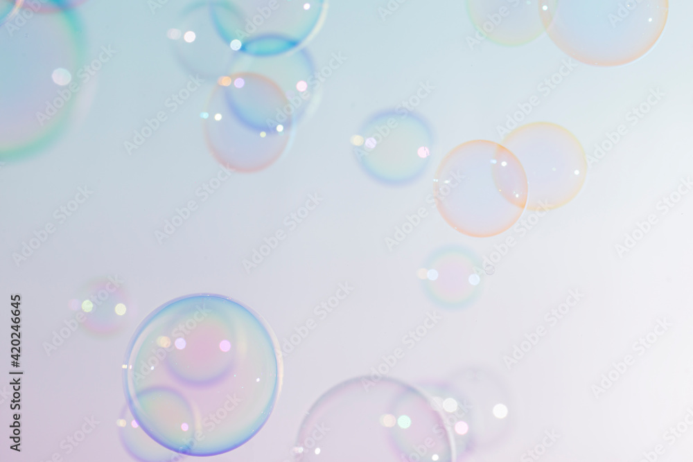 Beautiful shiny transparent colorful soap bubbles floating background.