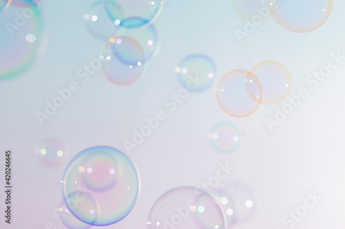 Beautiful shiny transparent colorful soap bubbles floating background.