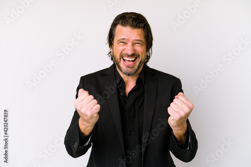 Middle age business dutch man isolated on white background celebrating a victory or success, he is surprised and shocked.