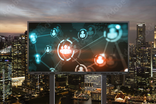 World planet Earth map hologram and social media icons on billboard over night panoramic city view of Singapore, Southeast Asia. Networking and establishing new connections between people. Globe