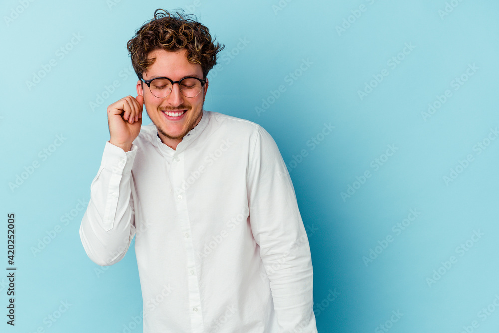 Young caucasian business man isolated on blue background dancing and having fun. Young caucasian business man isolated on blue background dancing and having fun.