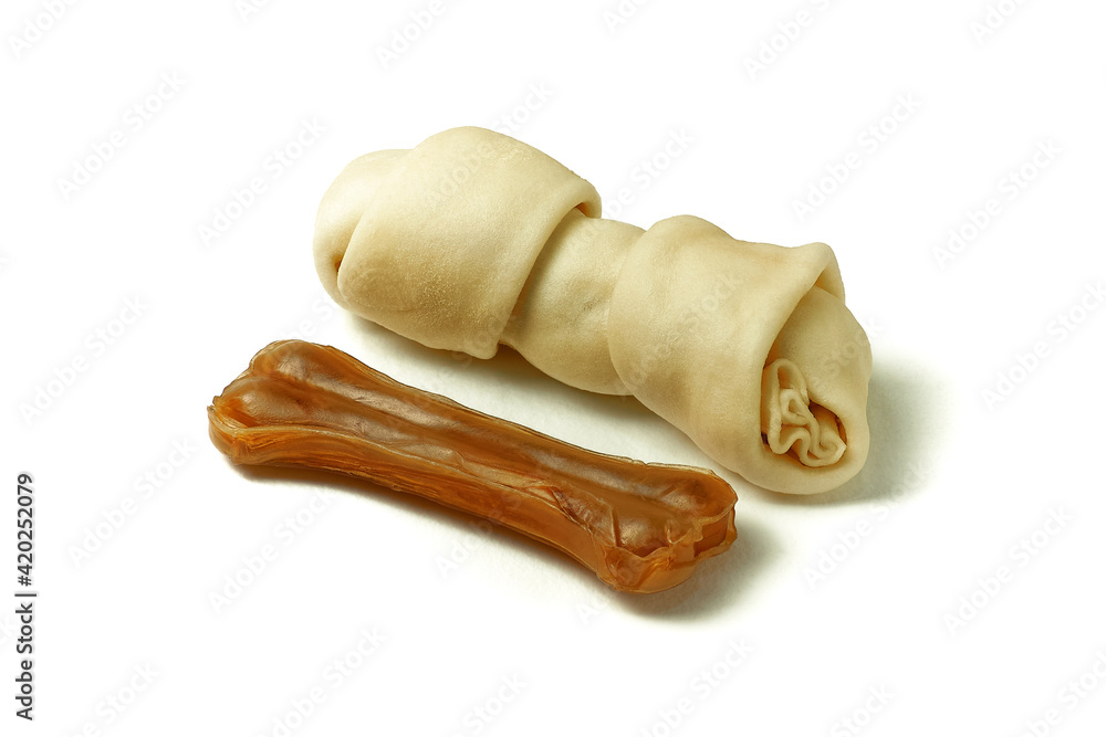 Dog chew bones on white background. Pressed and rawhide dog bones. Dog treats. Dog chew bones on white background. Pressed and rawhide dog bones. Dog treats.
