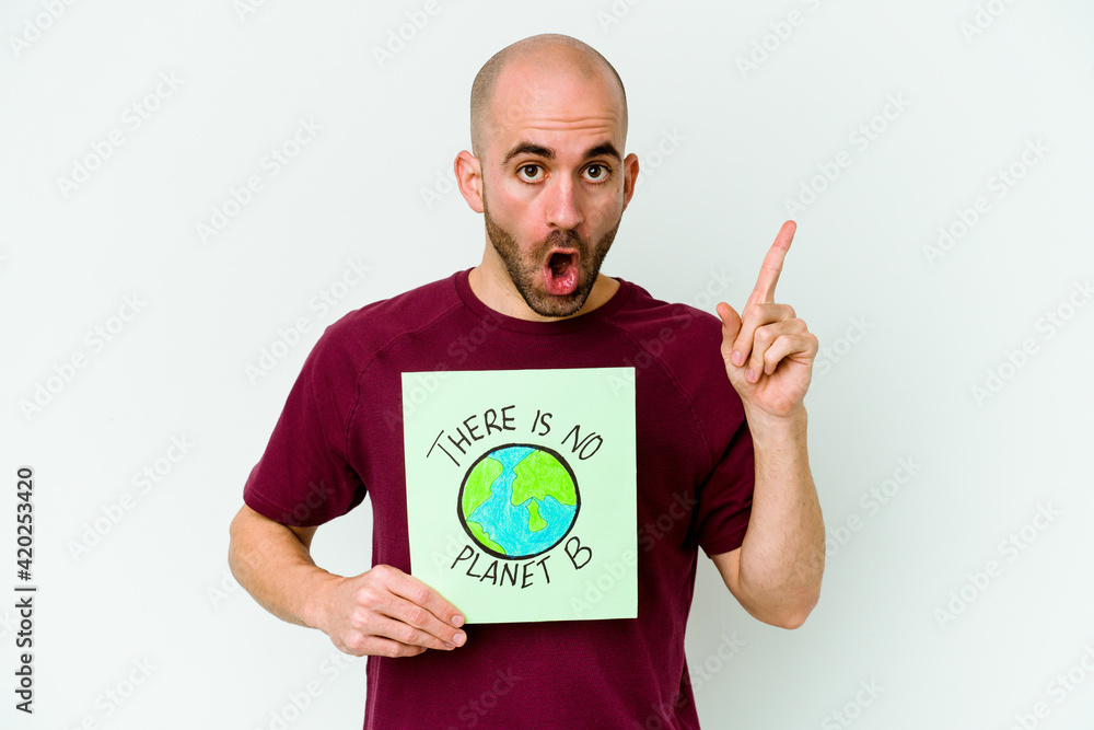 Young caucasian bald man holding a there is not planet B placard isolated on purple background having an idea, inspiration concept. Young caucasian bald man holding a there is not planet B placard isolated on purple background having an idea, inspiration concept.
