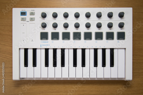 White midi keyboard with knobs and pads