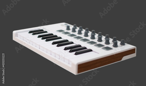 White midi keyboard with knobs and pads