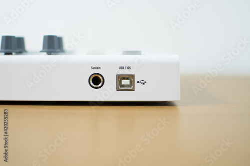 White midi keyboard with knobs and pads