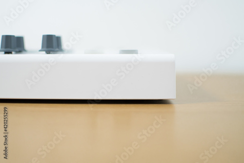 White midi keyboard with knobs and pads