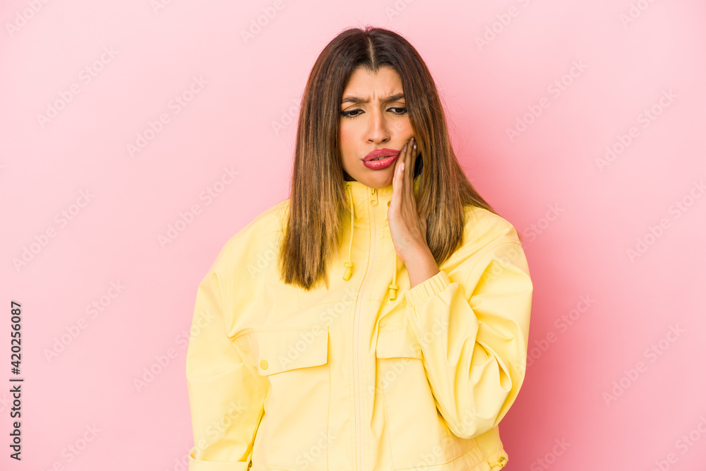 Young indian woman isolated on pink background having a strong teeth pain, molar ache. Young indian woman isolated on pink background having a strong teeth pain, molar ache.