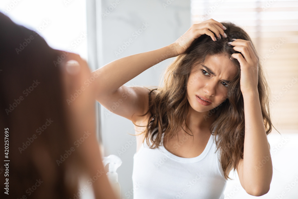 Unhappy Woman Looking At Hair Flakes Having Dandruff Problem Indoor - obrazy, fototapety, plakaty 
