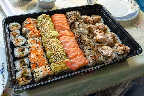 Lots of sushi rolls on the table. Sushi set with a variety of rolls