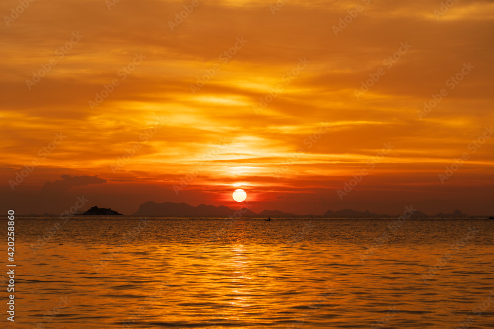 Beautiful sunset over the sea water on the island of Koh Phangan, Thailand