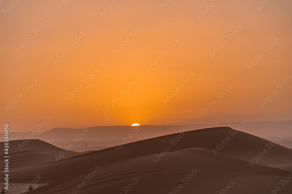 Sunset between sand dunes