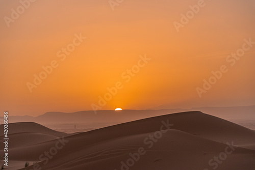 Sunset between sand dunes