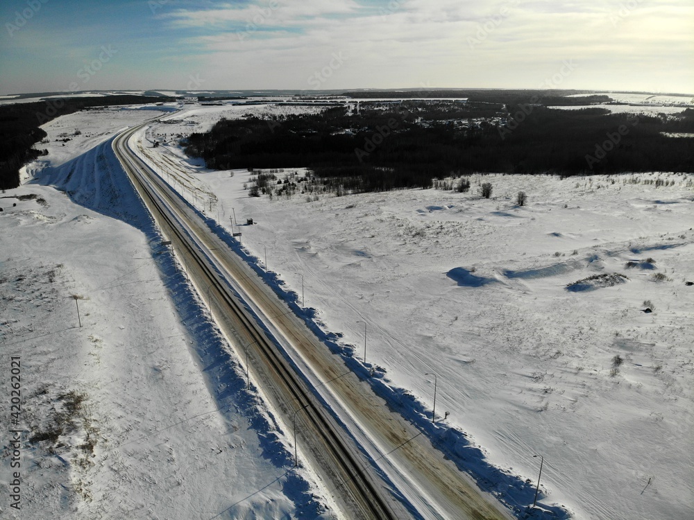 road highway in snowy fields without cars people Aerial drone view Flying over road highway in snowy fields without cars people Aerial drone view Flying over