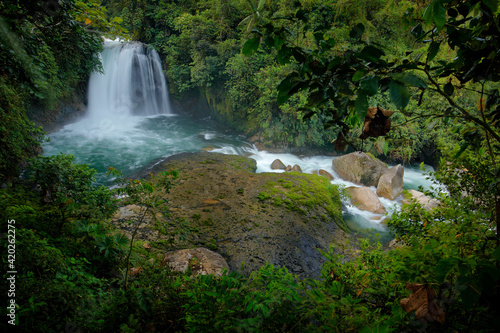 Ecuador waterfall  river with white stream  rainy day  green vegetation in national park Sumaco. Green tropical forest  with waterfall in South America. Tropic nature landscape with river.