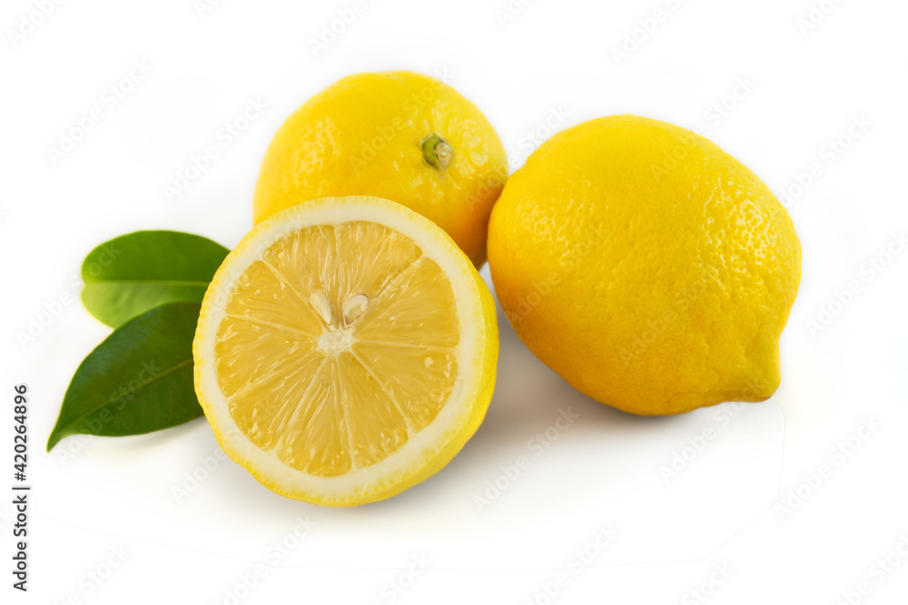 Lemon, half split in half, and two more, on a white background, with leaves, on the sides.