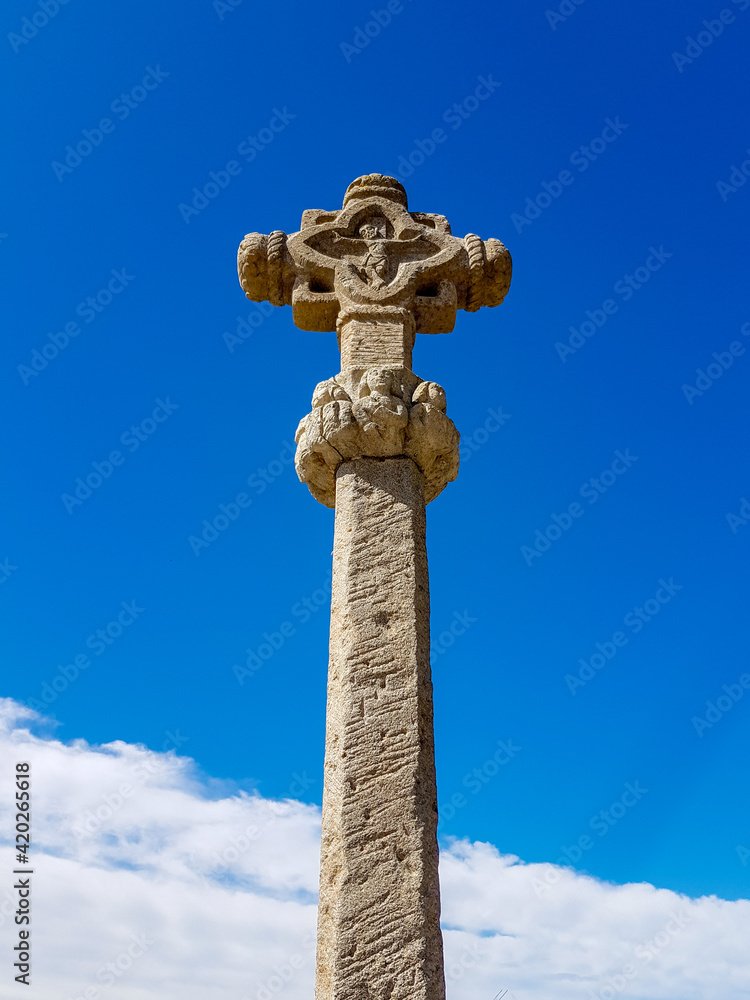 religious column with cross on top with blue sky background religious column with cross on top with blue sky background