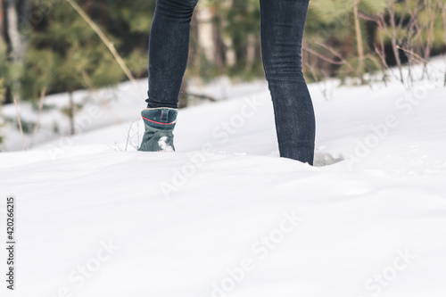 person walking in winter forest, girl stuck in snow