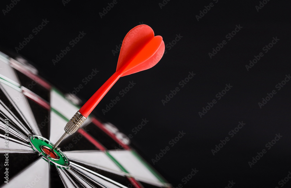 Red dart arrow on center of dartboard. Concept o business target, success and win. Red dart arrow on center of dartboard. Concept o business target, success and win.