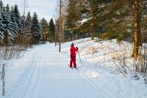 Small child in the ski track at winter forest in Finland.