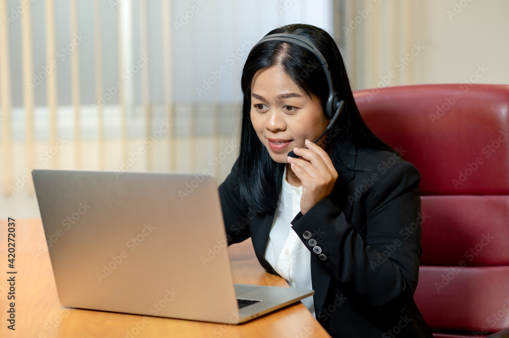 Online assistnt call center or customer support concept, office worker woman with headphone and laptop computer in work place Online assistnt call center or customer support concept, office worker woman with headphone and laptop computer in work place