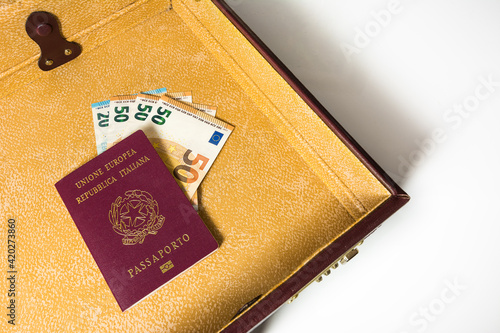 24 hour suitcase with passport and banknotes photo