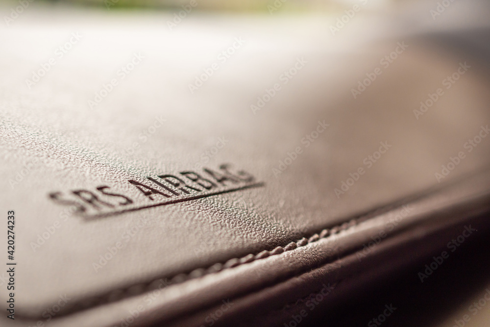 airbag safety sign on brown leather texture in modern car airbag safety sign on brown leather texture in modern car