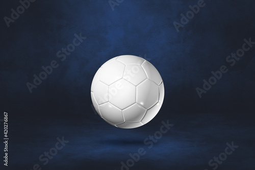 White soccer ball on a dark blue studio background