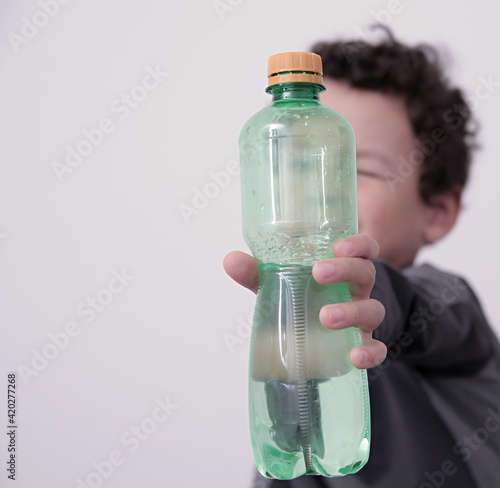 drinking water from a bottle with white background stock photo