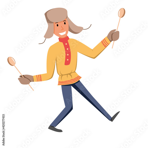 A cute boy in national clothes plays on wooden spoons.