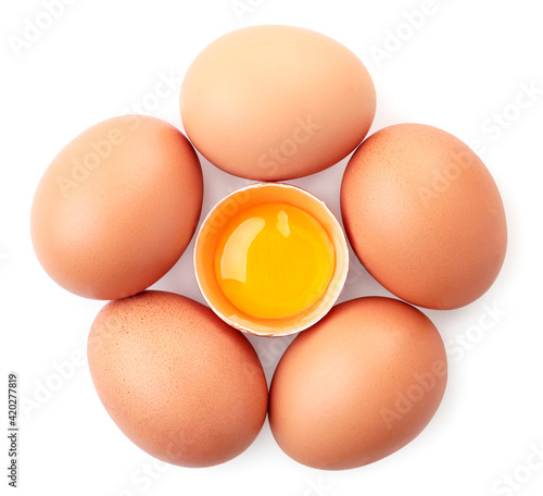 Whole and half brown eggs on a white background, isolated. Top view