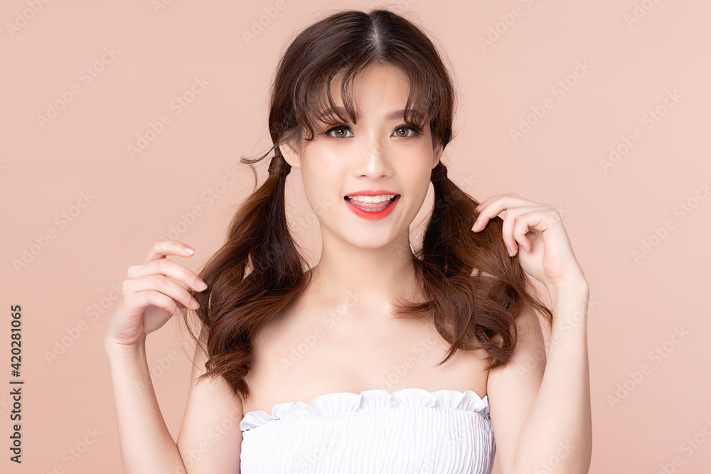 Beauty young asian woman has two pigtails and smiles clean fresh bare skin concept. Asian girl beauty face skincare and health wellness, Facial treatment, Perfect skin, Isolated on beige background. Beauty young asian woman has two pigtails and smiles clean fresh bare skin concept. Asian girl beauty face skincare and health wellness, Facial treatment, Perfect skin, Isolated on beige background.