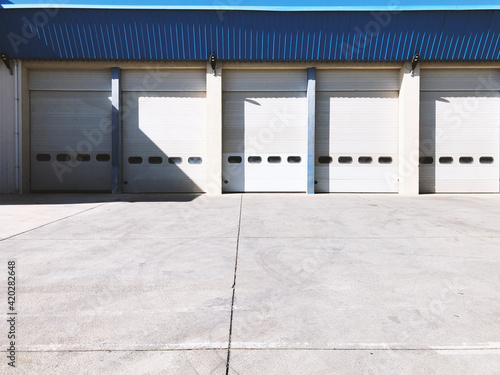 Hangar gates with blue roof and concrete floor.