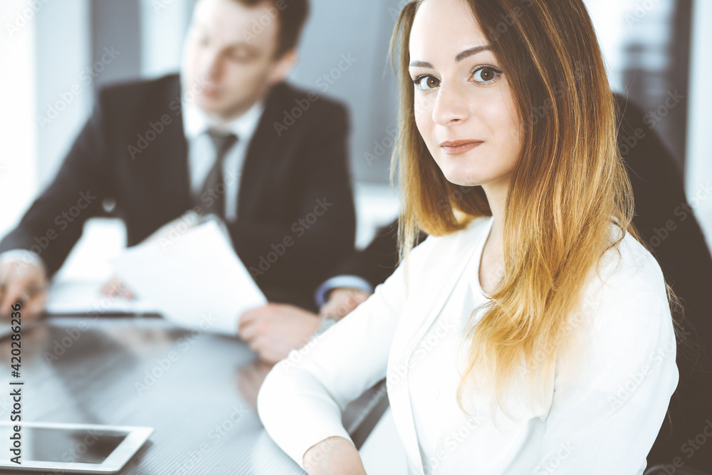 Business woman headshot at workplace in modern office. Unknown businesswoman sitting behind computer monitor. Young accountant or secretary looks good Business woman headshot at workplace in modern office. Unknown businesswoman sitting behind computer monitor. Young accountant or secretary looks good