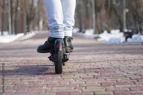 guy rides an electric scooter in the park