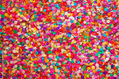 Confetti background, basis for a festive design or a postcard. Carnival, abstract wedding or birthday backdrop. Colored circles from paper