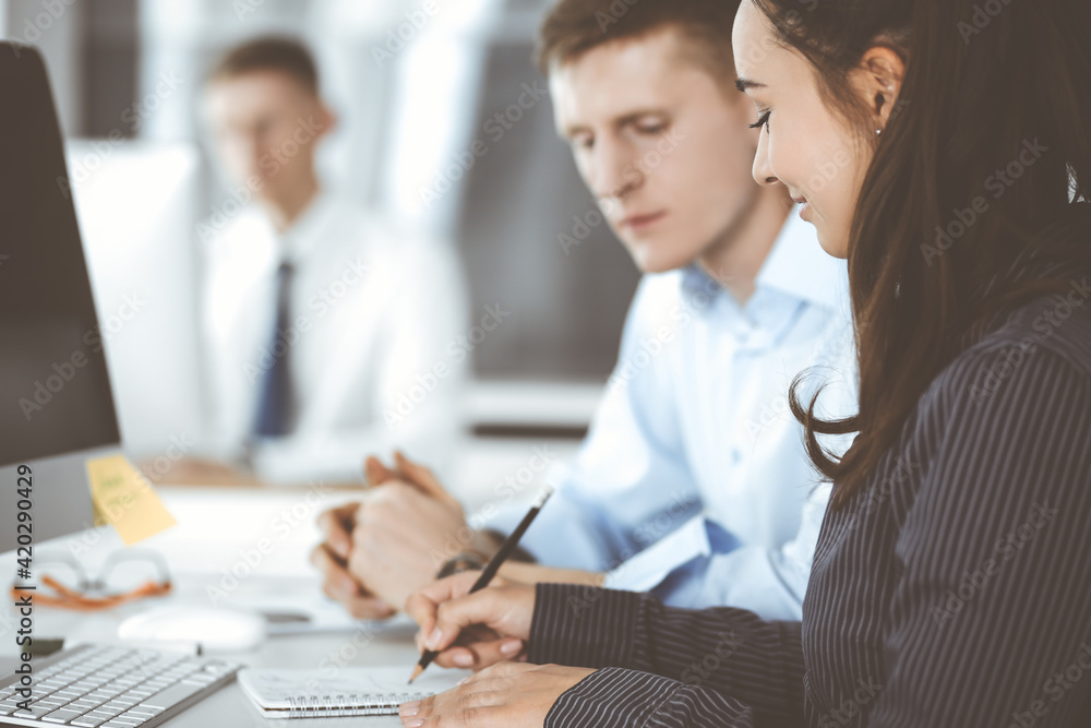 Business woman and man discussing questions while using computer at workplace in modern office. Teamwork, meeting and brainstorming concept Business woman and man discussing questions while using computer at workplace in modern office. Teamwork, meeting and brainstorming concept