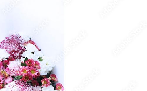 A bouquet of pink roses and crimson alstroemeria on a white background is a festive floral arrangement. Background for greeting cards, greetings, invitations. photo