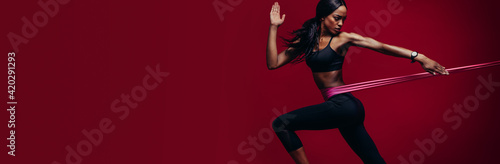 Tablou pe pânză Strong woman exercising with a resistance band