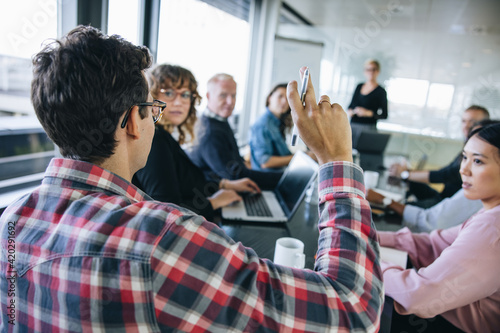 Photos Businessman asking a question in meeting