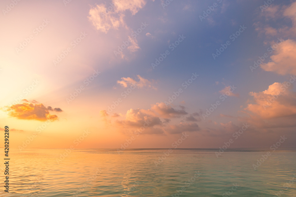 Sea ocean horizon. Skyscape with seascape. Orange and golden sunset sky, soft sand, calmness, tranquil relaxing sunlight, summer mood. Inspirational nature view, wide horizon of the sky and the sea
