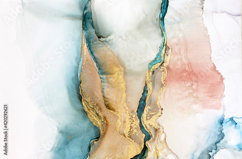 Abstract blue-green background with gold and beautiful smudges made with alcohol ink and golden acrylic. Fragment of art with turquoise texture resembles watercolor or aquarelle painting. © Luvricon