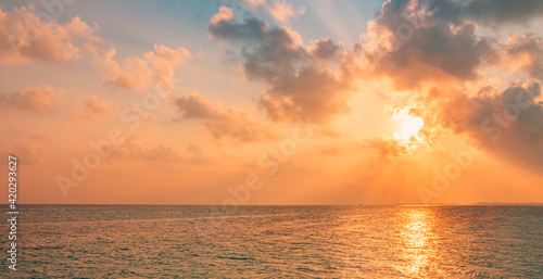 Sea ocean horizon. Skyscape with seascape. Orange and golden sunset sky  soft sand  calmness  tranquil relaxing sunlight  summer mood. Inspirational nature view  wide horizon of the sky and the sea