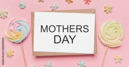 Gifts with note letter on isolated pink background with sweets, love and valentine concept with text mothers Day