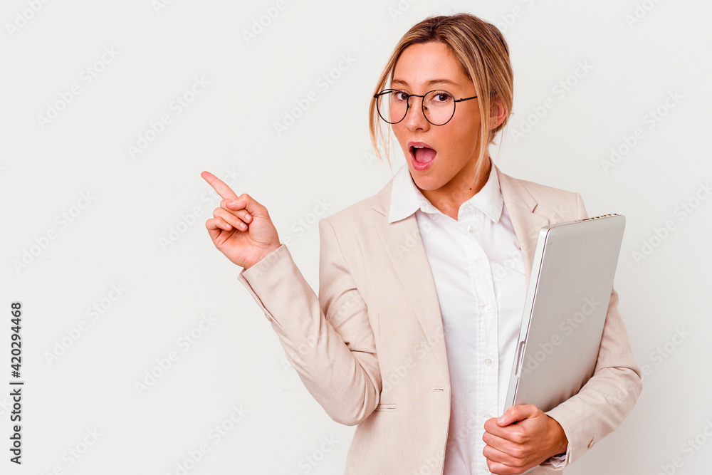 Young caucasian business woman holding a laptop isolated on white background pointing to the side Young caucasian business woman holding a laptop isolated on white background pointing to the side