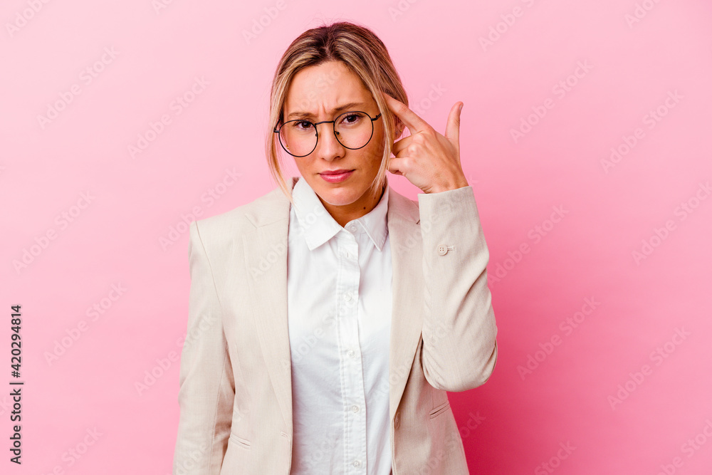 Young caucasian mixed race business woman isolated on pink background showing a disappointment gesture with forefinger. Young caucasian mixed race business woman isolated on pink background showing a disappointment gesture with forefinger.