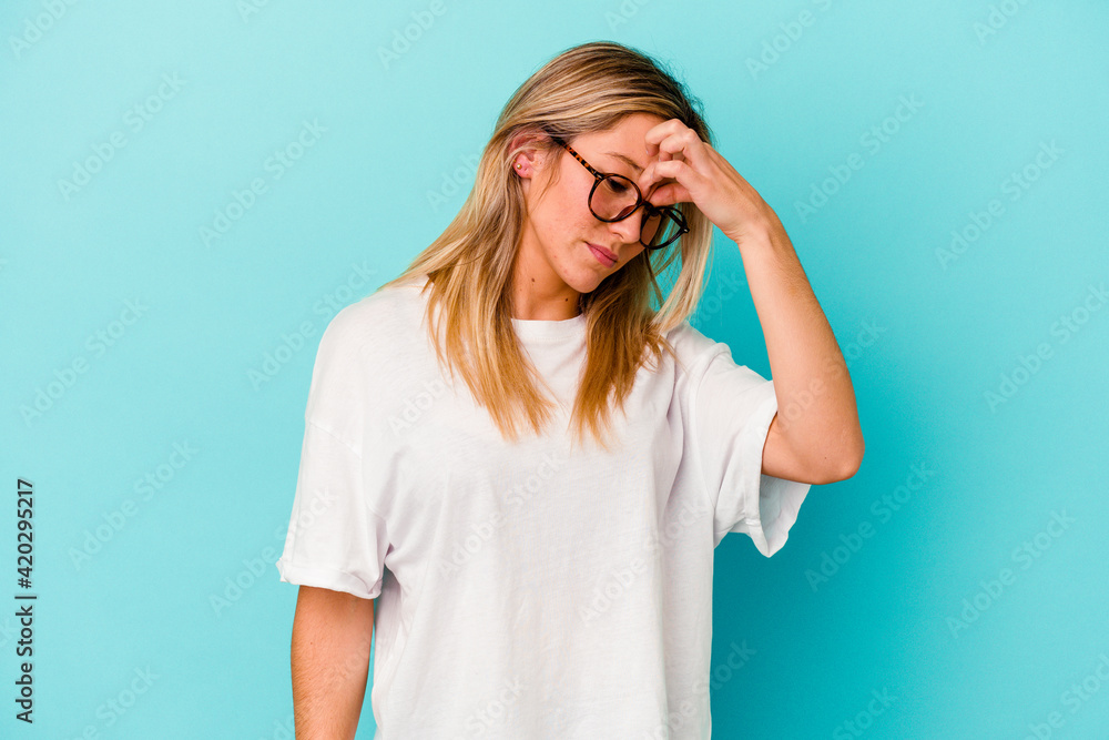 Young mixed race woman isolated on blue background having a head ache, touching front of the face. Young mixed race woman isolated on blue background having a head ache, touching front of the face.